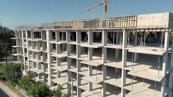 Aerial view Concrete frame of multi storey building under construction with visible crane video