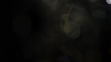 Captivating bokeh lights with rainbow refractions create a warm, magical, and ethereal atmosphere for festive designs. video