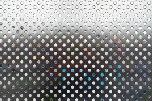 Silver Perforated Metal Sheet Background. a versatile and visually interesting texture for various design projects, from industrial and technology themes to abstract and modern concepts. photo