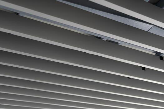 Modern Metal Ceiling Structure with Parallel Lines. Minimalist industrial style background, suitable for construction, architecture, and design concepts. photo
