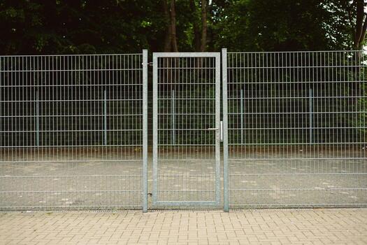 A modern steel gate with durable wire mesh enhances accessibility in outdoor spaces, serving as a secure and visually striking addition that contributes to the environments aesthetic appeal photo