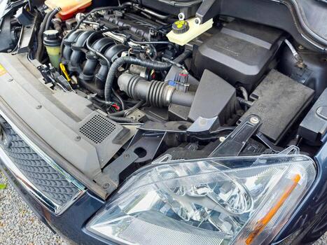 Close-up view of a car engine reveals intricate details of machinery and design during a routine maintenance check in a mechanic's garage photo