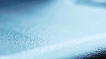 An abstract macro shot of a soft blue texture, like frost on a window or fabric fibers. A calm and cold, dreamy background with a shallow depth of field. video