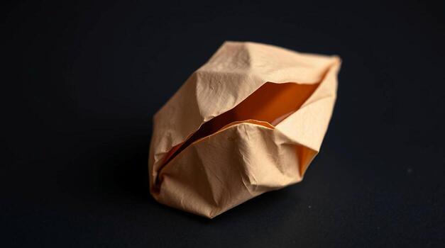 A folded piece of paper sitting on a black surface photo