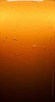 Close up macro shot of refreshing amber colored liquid with tiny bubbles and a gradient effect photo