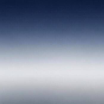 Serene gradient of deep blue sky fading into soft white clouds and hazy horizon photo