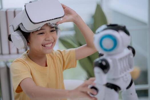 Asian girl smiling while lifting VR headset and playing with robot toy, enjoying immersive technology and robotics. Concept of child happiness, creativity, digital learning and future innovation. photo