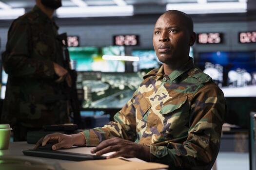 Army telecommunication systems professional using radio and satellite devices, providing combat support. Military unit managing communications networks, looking at displays photo