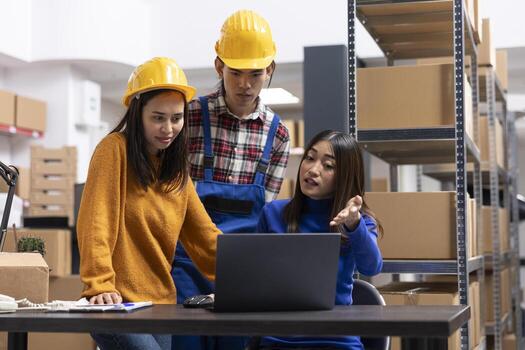 Employees team organizing boxes and goods in depot of a local retail business, small scale distribution hub with inventory on racks. Product handling and order processing for local shipping. photo