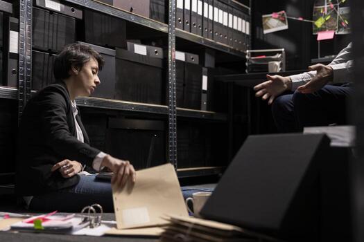 Two private detectives analyzing case files and archived information, tracing and connecting evidence between suspects and organized crime in a secret mission. Clandestine operation. photo