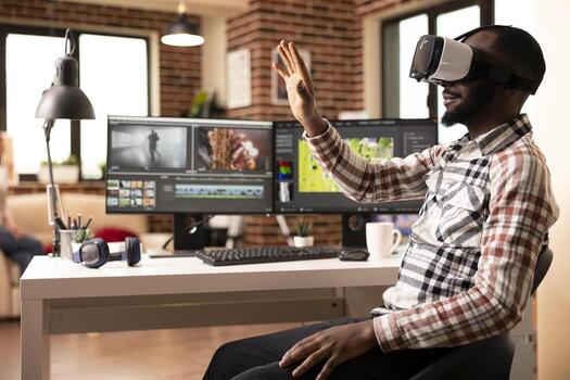 Black filmmaker editing multimedia with vr glasses and advanced software. African american male editor working from home, using virtual reality tools in completing post production movie project. photo