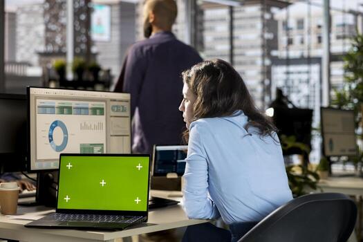 Business analyst reviewing budget numbers next to isolated chroma key, allocating all resources accordingly for development. Accomplish objectives for company growth, networking. photo