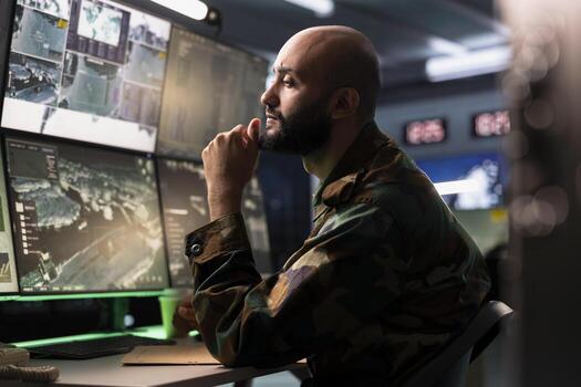 Air defense operative in war room using radar to detect ballistic missiles. Army soldier in base of operations scanning rockets approaching national borders using satellite hardware, deploying shields photo