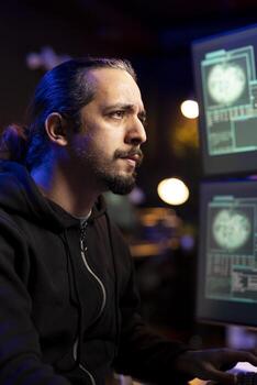 Hacker frowning after being unable to do phishing attacks and trick users into revealing credit card data. Man annoyed after DDoS attacks fail to flood servers and crash websites photo