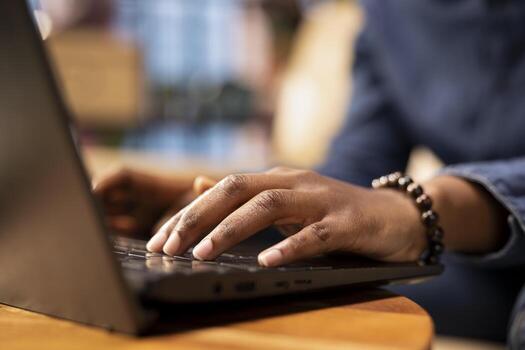 Person at home browsing internet on laptop and researching information online, accessing websites and reading articles while she sits on the couch. Find data relevant to work tasks. Close up. photo