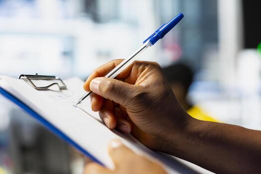 Male technician in solar panel factory reviews photovoltaic system performance on clipboard files. Worker analyzing production line guidelines to optimize efficiency, troubleshooting. photo