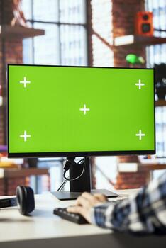 Employee in home office editing documents on chroma key computer, updating reports and files, typing. Close up of man managing digital paperwork within file directories on isolated screen PC display photo