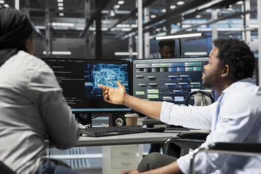 Data center manager and engineer with paraplegia using artificial intelligence computerized model. Server room team leader and worker in wheelchair using machine learning AI algorithms photo