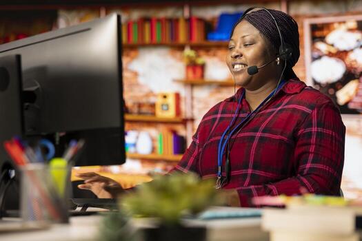 Smiling call center agent talking in headset microphone, helping customers regain access to accounts and devices. Happy woman in customer center assisting clients needing help resetting password photo