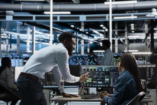 Data center admins programming infrastructure used for machine learning training. Server hub IT professionals collaborating running code on PC to upgrade artificial intelligence systems photo