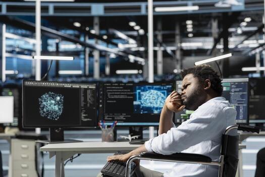 Data center worker with disability in wheelchair using deep learning algorithms to analyze datasets. Person with paraplegia in inclusive server hub using AI to recognize data patterns photo