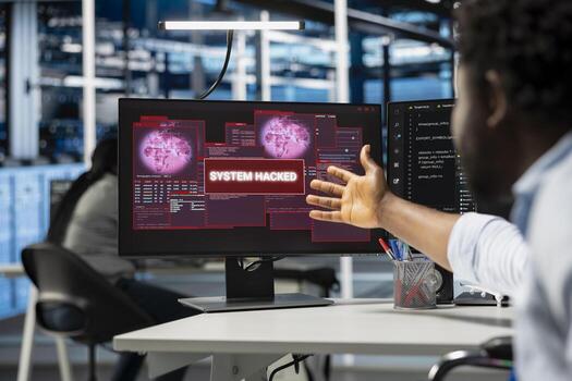 Close up of computer scientist in server hub asking coworker for help, trying to protect equipment from hacker. IT specialist in data center facility requesting assistance to fix security breach alert photo