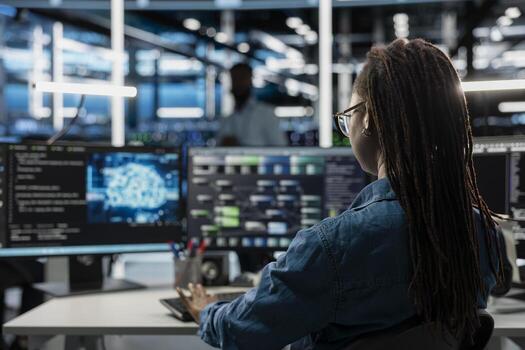 Engineer using AI computer to do checkup in server room providing vast computing resources and storage, enabling artificial intelligence to process massive datasets for training and inference photo