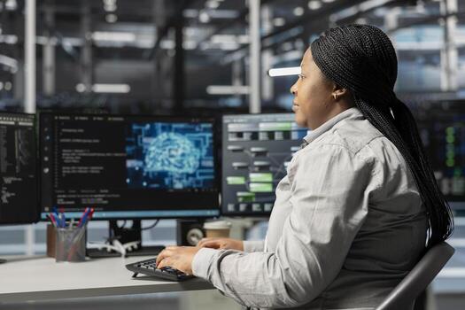 Data center computer scientist using artificial intelligence neural networks technology. Woman working in server room using AI programming language on computer, configuring specialized hardware photo