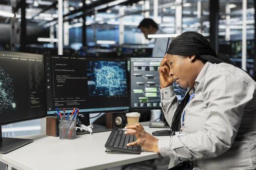 Tired engineer in pain suffering from headache while setting up data center equipment needed to run artificial intelligence. Fatigue server room worker affected by migraine using AI tools photo