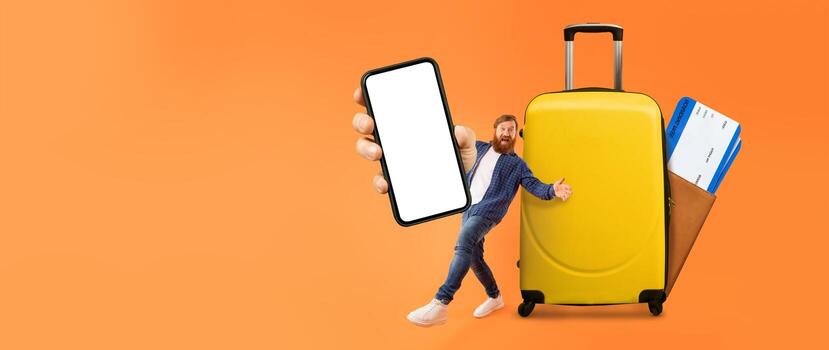 A man stands beside a bright yellow suitcase while holding a smartphone displaying a blank screen. He appears ready for vacation, emphasizing the importance of travel apps in summer adventures. photo