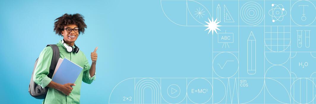 A student stands confidently against a colorful painted background, giving a thumbs up while holding a notebook. This lively setting emphasizes a positive attitude toward education and learning. photo