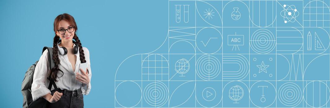 A student stands smiling with a backpack while holding a smartphone. The vibrant painted background features various educational icons, creating an engaging study atmosphere. photo