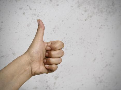 fist hand showing up in the air.body language,sign and symbol for Like and rejoice,in front of background, photo