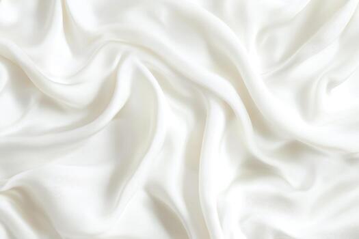 Soft white fabric draped on a surface with gentle folds photo