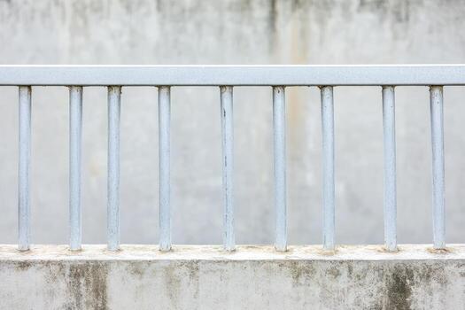 Metal railing against a plain wall in a quiet setting photo