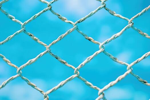 Close-up view of a weathered wire fence against water photo
