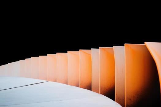 Modern curved chairs in a minimalist setting at sunset photo