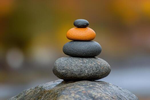 Balanced stone tower in nature during autumn photo