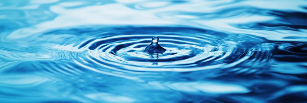 Drop creates ripples in clear water surface photo