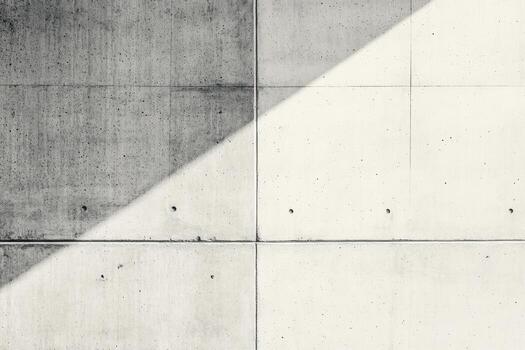 Concrete wall with textured patterns and diagonal shadow photo
