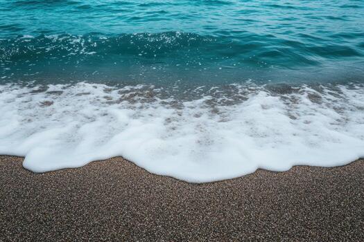 Waves gently crashing on a sandy beach at midday photo