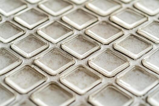 Unique pattern of silver square tiles closeup in natural light photo