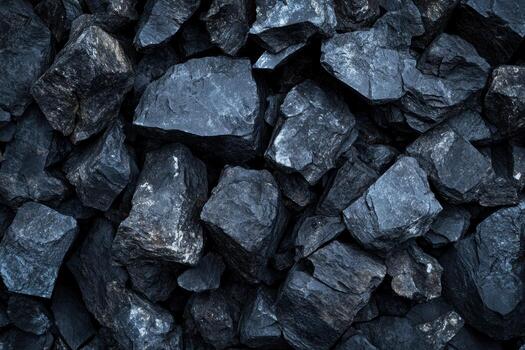 Dark coal rocks arranged in a textured formation photo