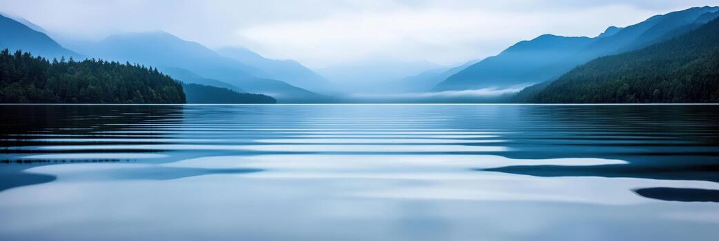 Serene lake view with misty mountains in the background photo