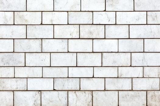 Textured white brick wall with uneven grout lines photo