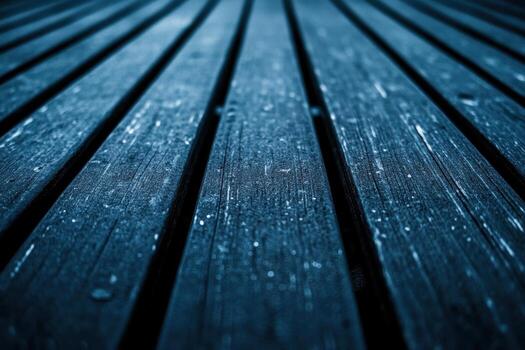 Wooden deck with water droplets in low light setting photo