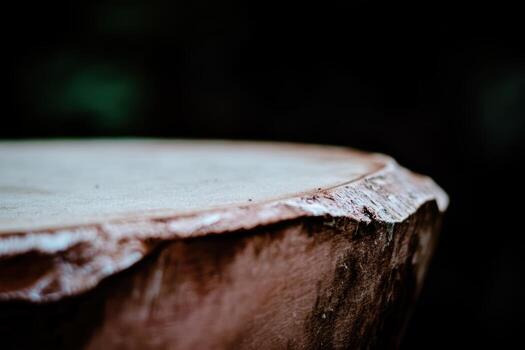 Close-up view of a wooden table edge under dim lighting photo