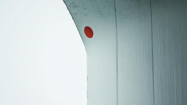 Red circle on a white wall creates striking visual contrast photo