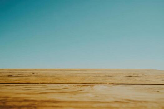 Wooden surface with clear blue sky in background photo