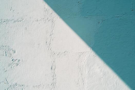 Light and shadow play on textured wall during sunny afternoon photo